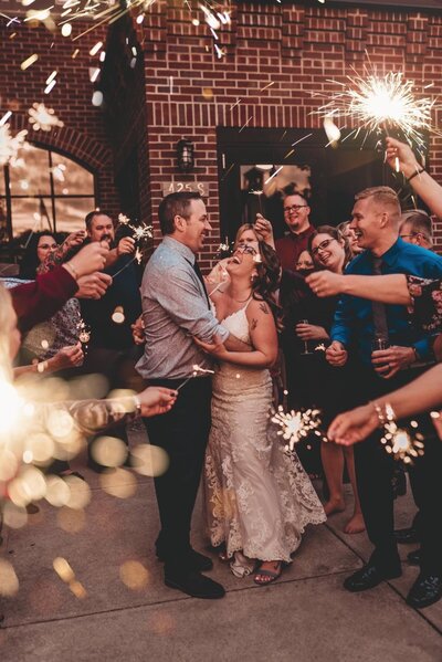 Bride and groom dancing by sparklers