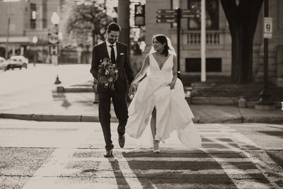 bride and groom walking through the street