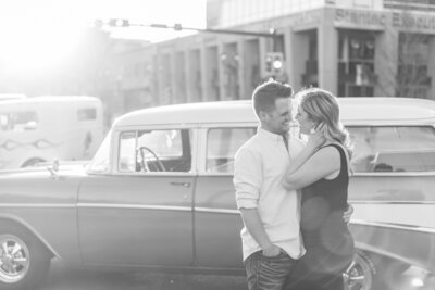couple getting engagement photos with classic car