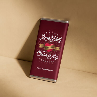 uxury personalised chocolate bar in deep red Valentine’s Day design reading “Every love story is beautiful but ours is my favourite”, created by Barilliant.