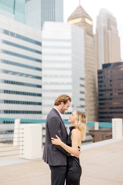 Man and woman look into each other's eyes during engagement photography session in Lake Minnetonka.