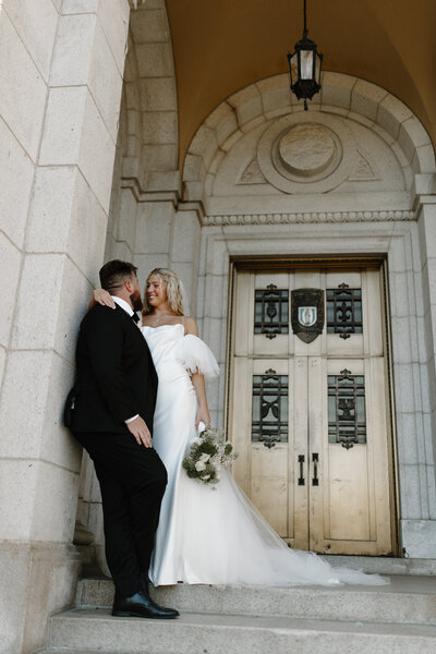 a bride and groom smiling at each other