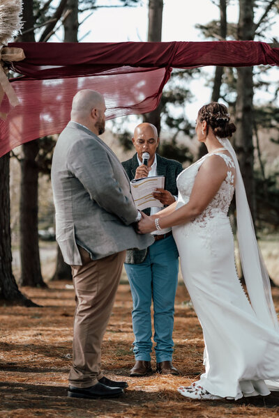 Bride and groom Nardus and Dehlia sharing first kiss at altar during Auckland wedding, photographed by Zanthe Vorsatz.