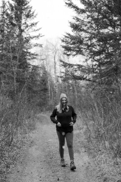 black and white image woman walking down trail