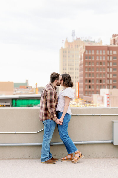 Relaxed couple shares a sweet moment overlooking the downtown Amarillo cityscape