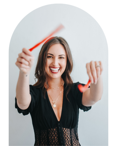 woman smiling and holding red straws