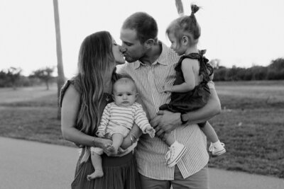 Parents Kissing with Children Laughing