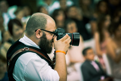 Three16 Photography owner Jerrick O'Connor takes photos during a wedding ceremony