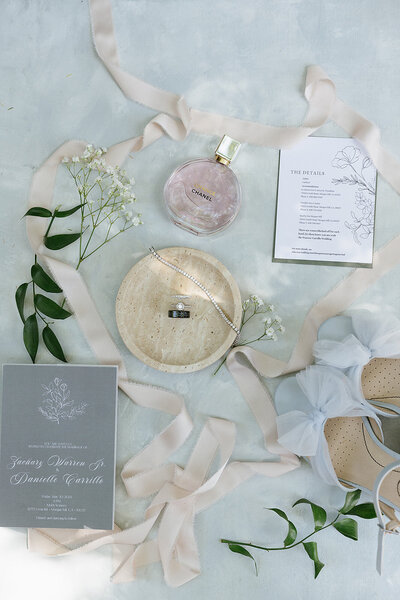 Flat lay of wedding invite green envelope white invite with green details on the invite. 