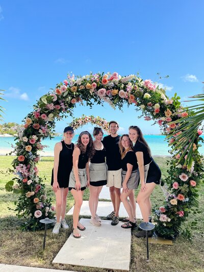 Wedding and Event Floral Design team at fall wedding in Raleigh, NC. Greenery ceiling and floral and event colors of dusty blue, pink, mauve, taupe, green, and cream. Wedding reception floral design by Rosemary and Finch in Nashville, TN.