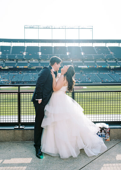 Katie Fri and her husband on their wedding day at Camden Yards, celebrating their love in Baltimore, MD.