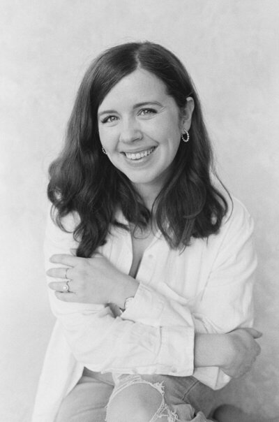 Minneapolis wedding photographer and newborn photographer, natalie bauer smiling and crossing arms
