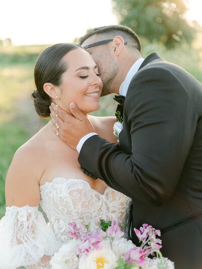 Tender moment between bride and groom at sunset, soft light and romantic atmosphere — Destination Wedding Photographer Portfolio.