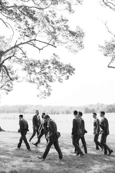 a black and white image of wedding guests twirling napkins to cheer on the newlyweds at a new jersey wedding venue