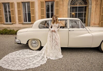 black and white image bride wearing feathered wedding dress
