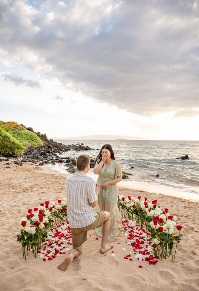 Hawaii Engagement Photographer captures man proposing in floral arch