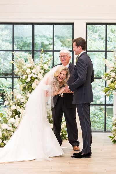 Bride laughs while taking her wedding vows