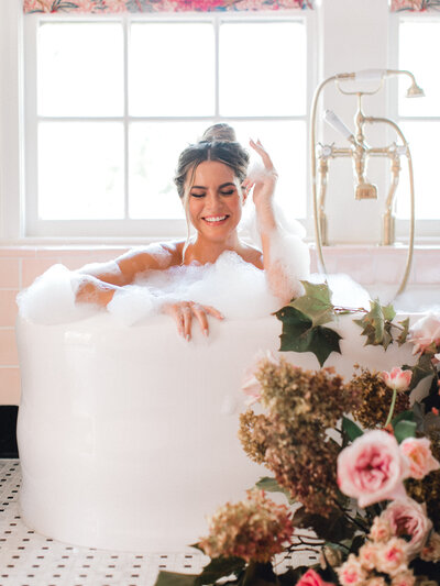 woman smiling in bubble bath