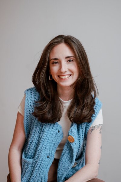 Liz holding a phone and looking at the screen