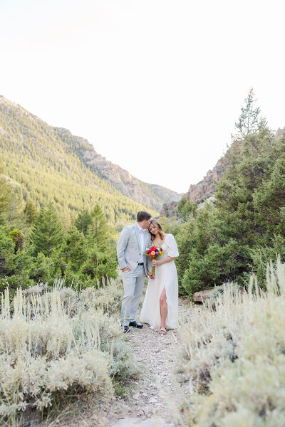 Bride and groom on their wedding day at Five Springs Campground in Lovell, Wyoming, with breathtaking mountain views as their backdrop.