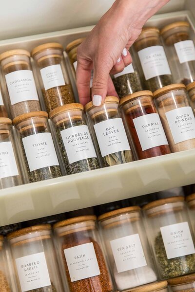 Organizing a spice drawer with glass containers and custom labels