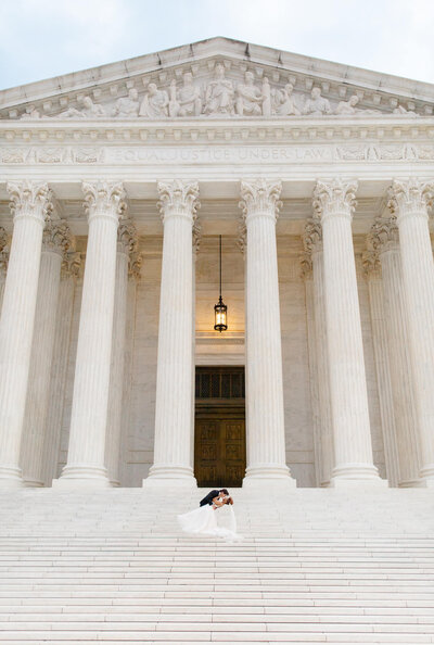 Groom dipping bride on the stairs of the United States Supreme Court. Taken by DC Wedding Photographer Bethany Aubre Photography.