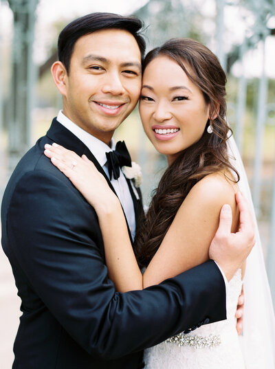 Bride and groom smiling at camera