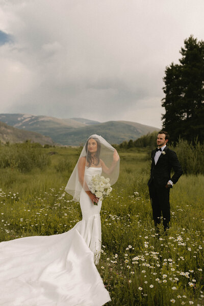 Bride and groom share an elegant moment during their luxury wedding at Camp Hale in Vail, Colorado. Captured by a film and digital, Denver-based wedding photographer. 