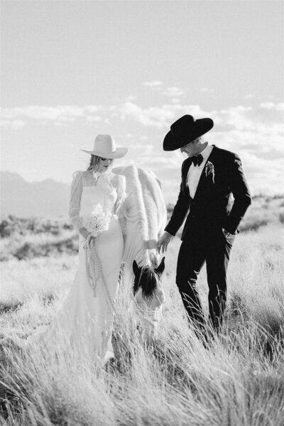 Married couple walking candidly while the bride holds her flowers.