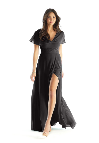 Married couple with their wedding party walking outside