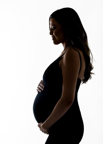 Backlit maternity portrait at Allison Reilly's Union County, NJ photo studio.