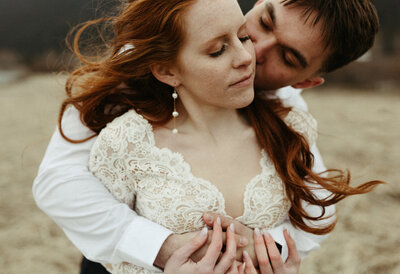 bride and groom holding onto one another
