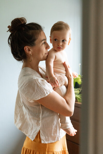 Mother wraps her hands around her son's head during a family photoshoot in Portland, Oregon.