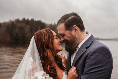 husband and wife going in for a kiss in old forge
