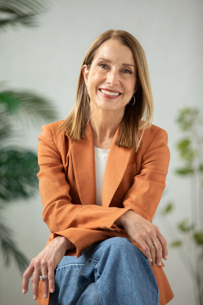 A confident woman, smiling, and conveying poise and professionalism