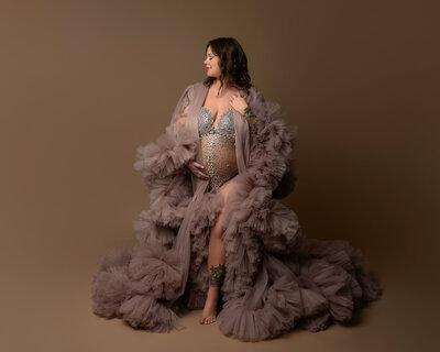 Sheer champagne sequin bodysuit with mauve tulle robe for maternity shoot