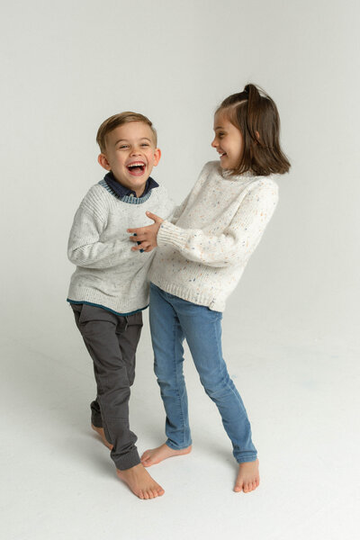 kids laughing during family portrait photography session
