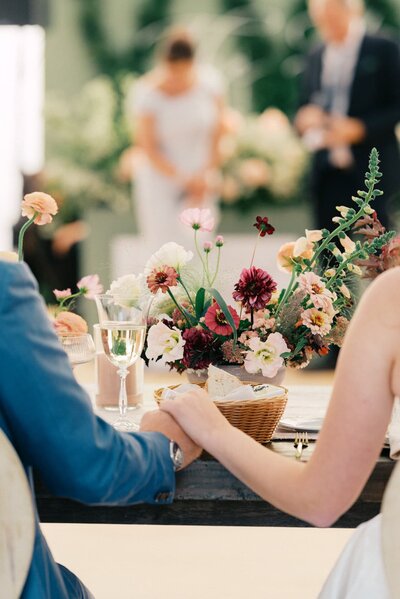 bride and groom holding hands