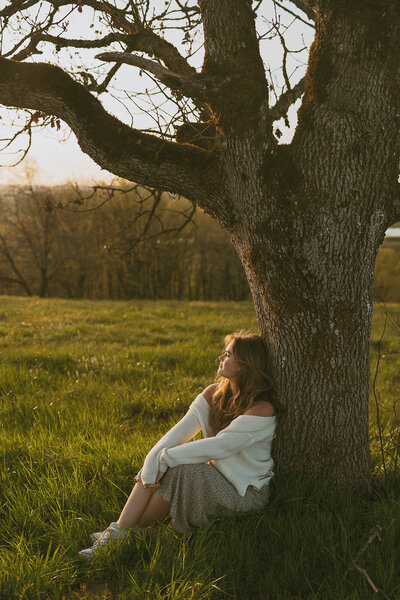 girl standing in field in front of mountainside view