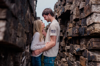 A couple poses for the camera with man caressing woman's face.