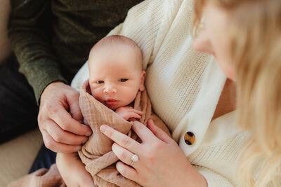 An expectant mom and dad embrace each other during their maternity photography session in madison, wi.