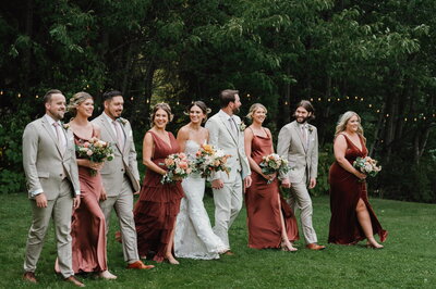 bridal party walking in grass