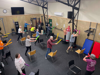 A group of Parkinson's warriors follow Lori during a group exercise in the Parkinson's Warriors gym in Eugene. 