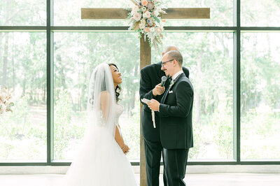 couple laughing during their ceremony at the luminaire