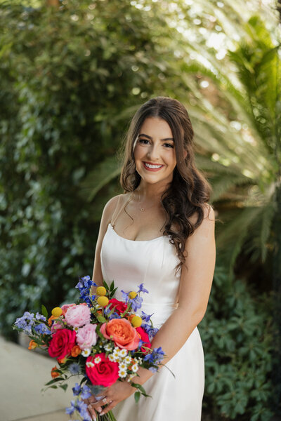 bride Savannah holding bouquet, wearing hypoallergenic bridal makeup by MaKall