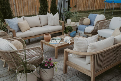backyard patio with two sofas and accent chairs with coffee table in the center