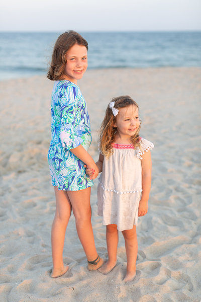 kids holding hands on the beach