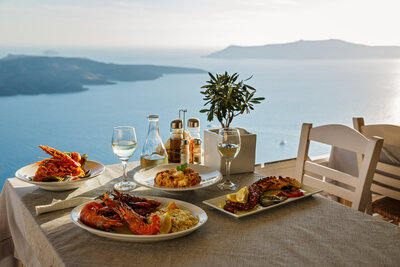 A beautifully set outdoor dining table offers gourmet dishes with stunning views, inviting cultural connection and enjoyment.