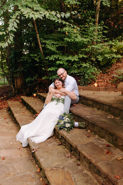 A couple holds one another on steps