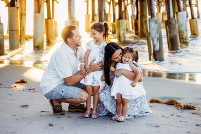 beautiful family session in Cocoa beach, florida. parents playing with their two young girls by the beach, captured by bia schaefer photography